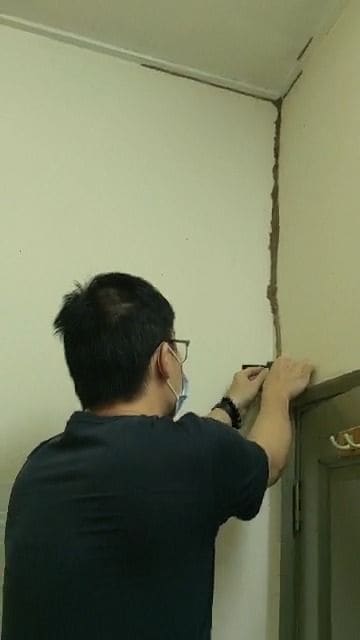 Technician installing an above-ground bait station on a termite mud tube